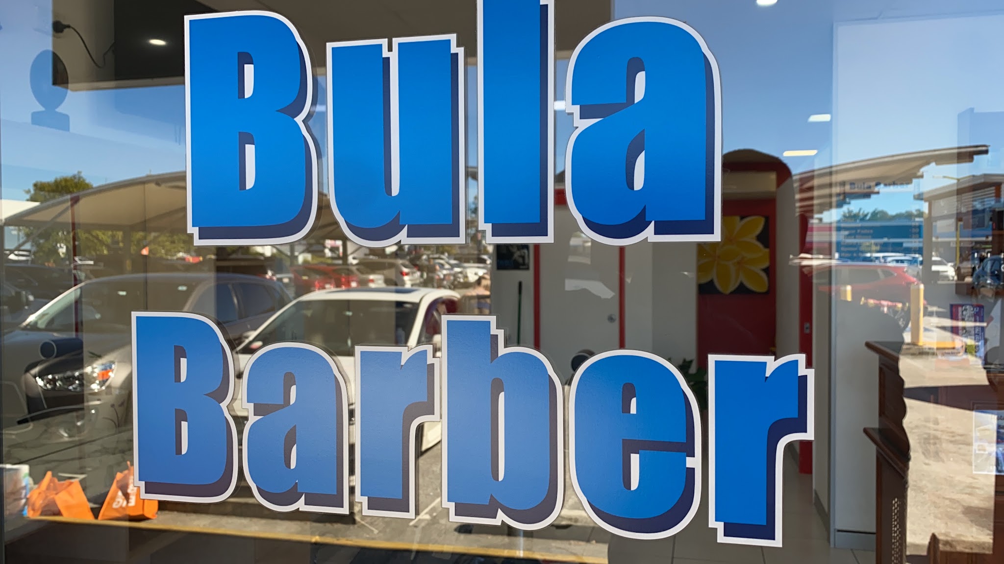 The Bula Barber lettering across the shop window